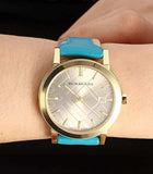  Shop Authentic Burberry The City Gold Dial Blue Leather Strap Watch for Women - BU9018 - Luxxuri